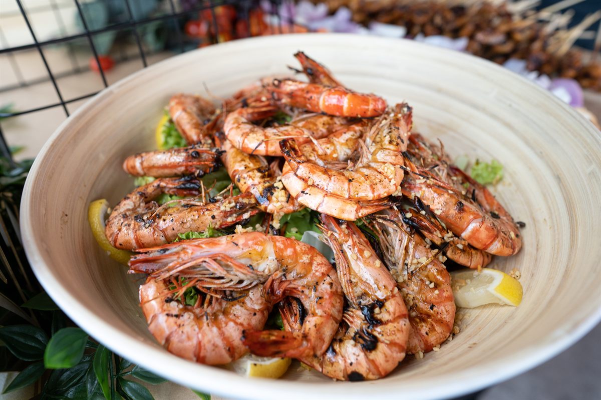 Grilled Sunday Roast prawns presented for a hosted BBQ table