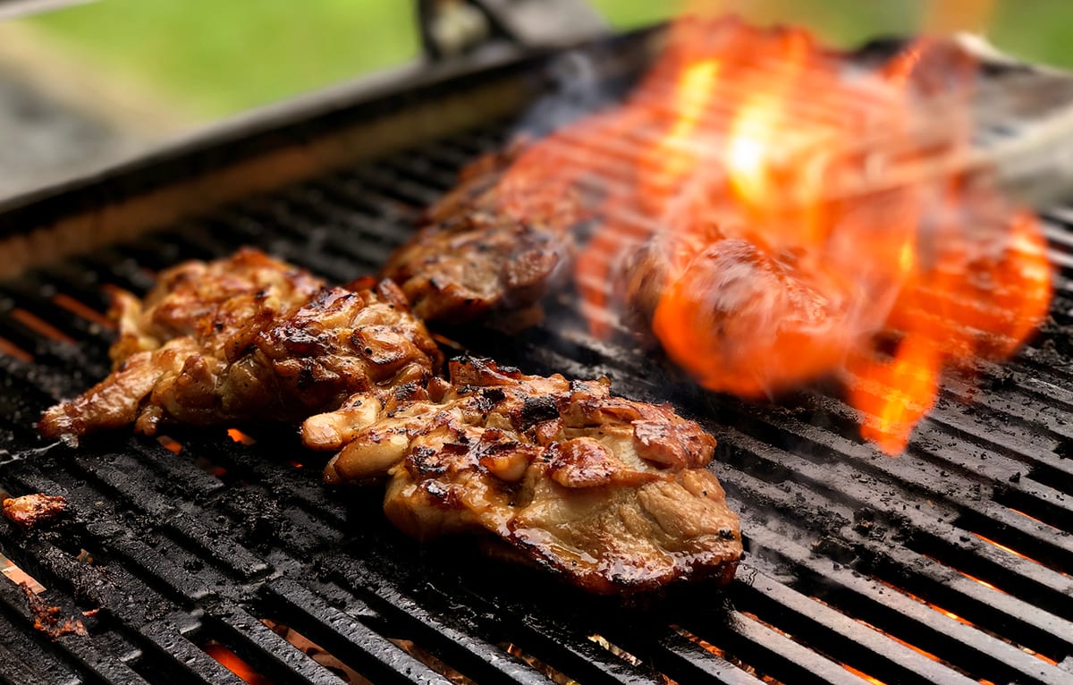 Sunday Roast honey soy chicken cooking over the BBQ flame