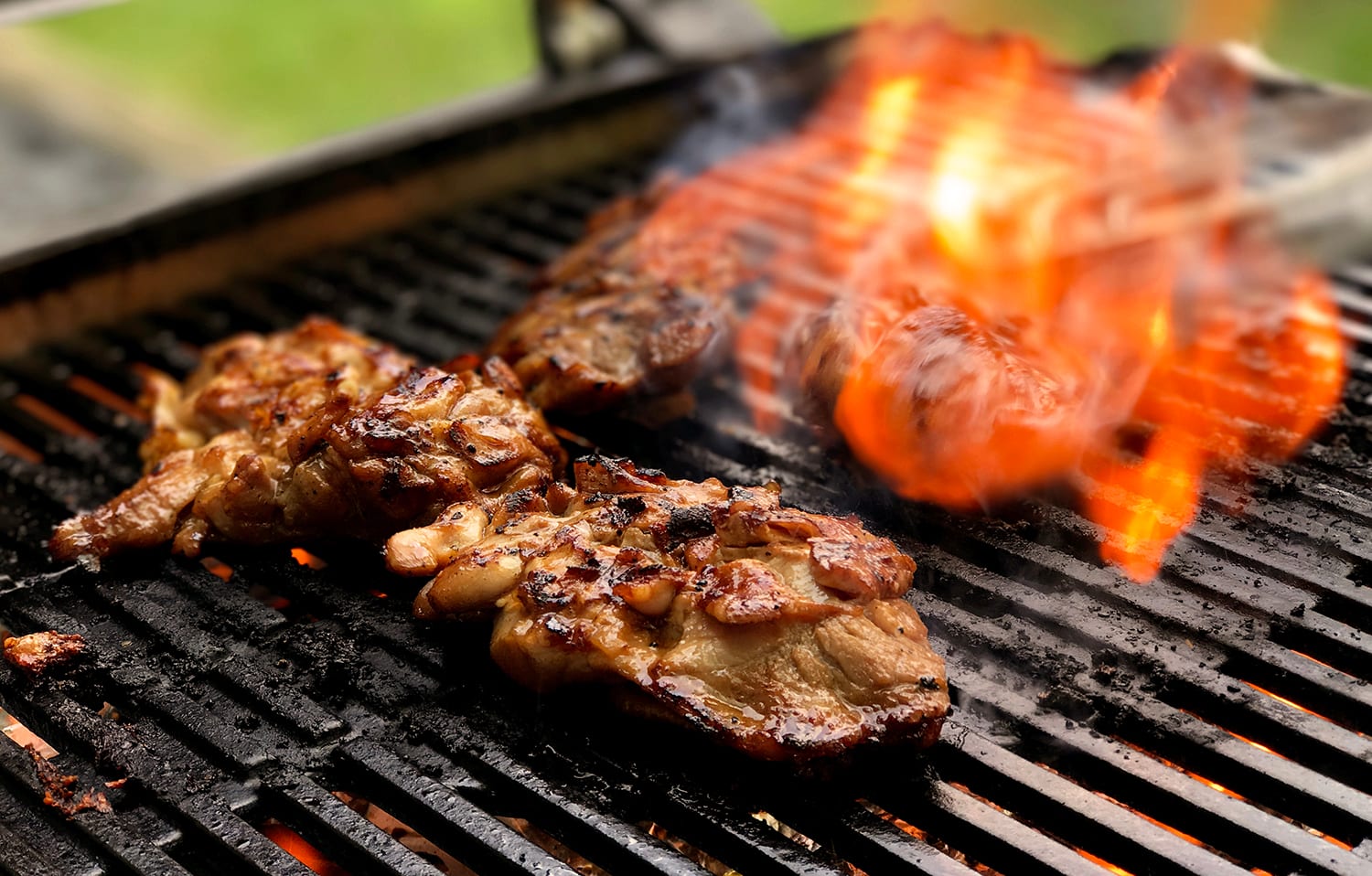 Chicken chops grilling over live fire for the Starter omakase BBQ tier
